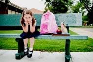 stock-photo-9979047-impatient-little-girl-student-waiting-on-bench-for-her-parents