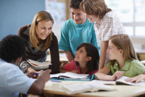 Teacher Assisting Group of Students